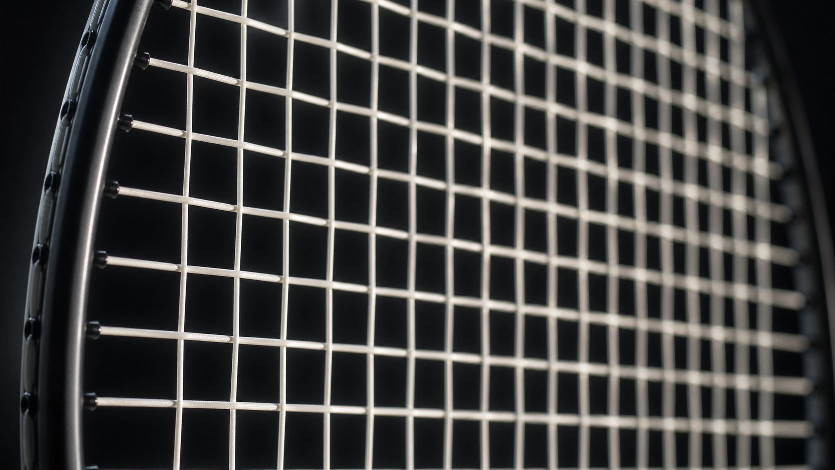 Close-up macro photograph of a badminton racket string bed showing the interwoven string pattern